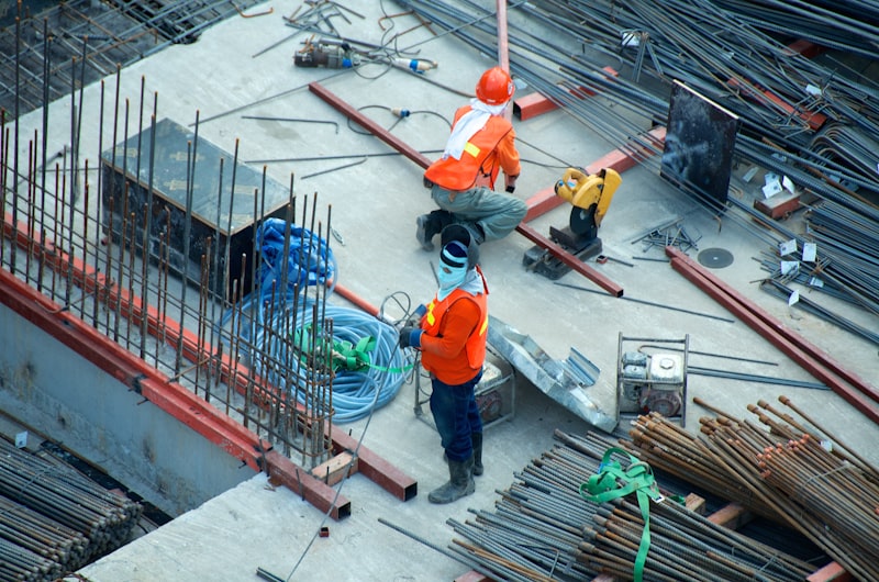 Construction workers and excavator on site